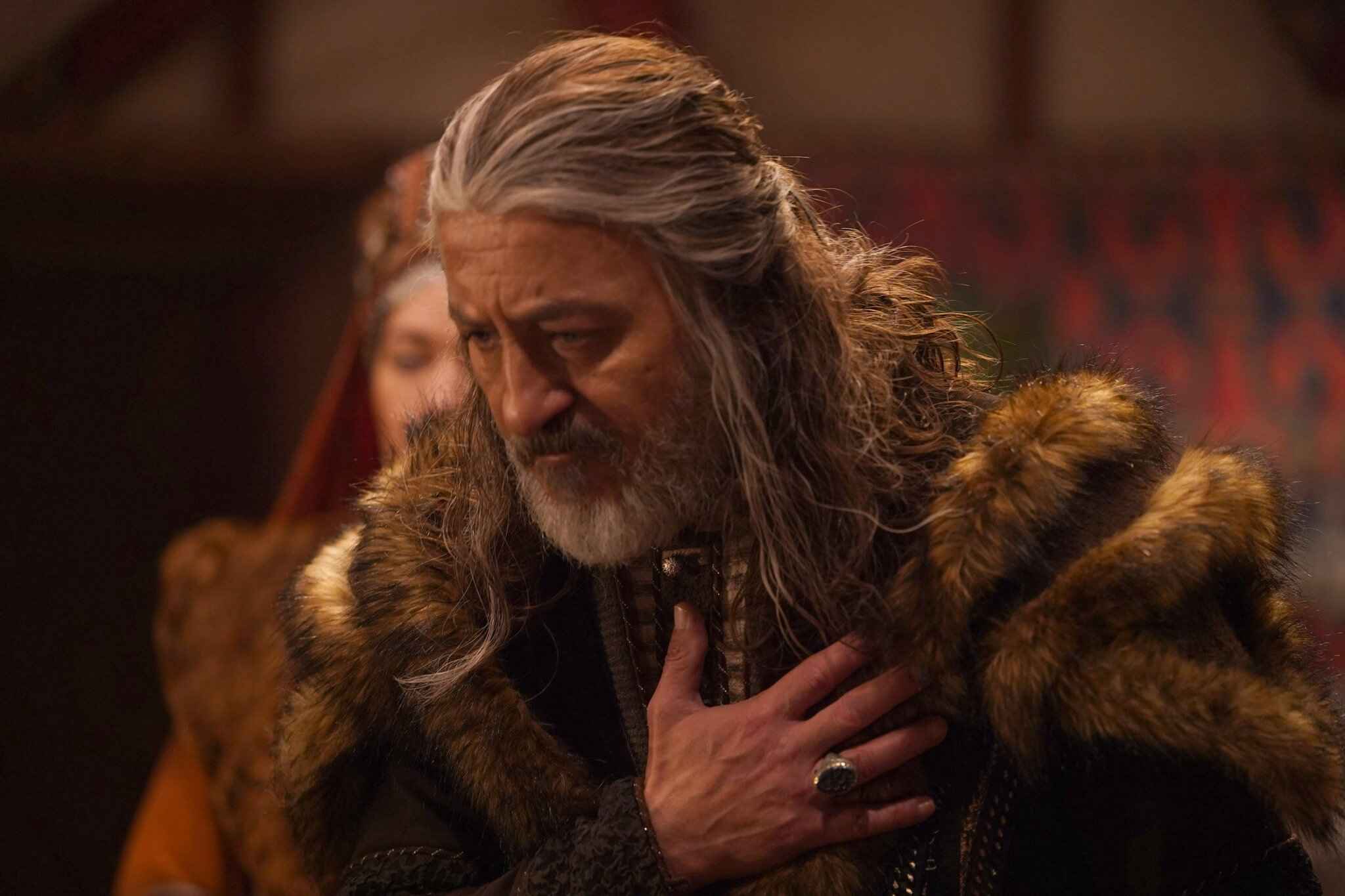 Temurtas smiling while plotting in the shadows